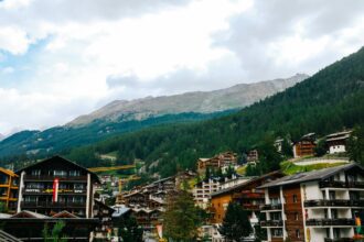 bergkristall oberstaufen - A charming Swiss town with wooden chalets amidst lush forested mountains,