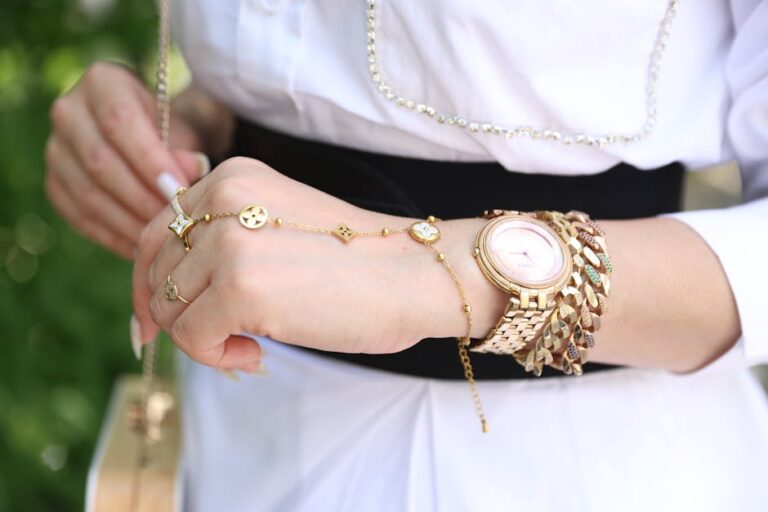 juwelier rieger - Close-up of a woman's wrist with elegant gold jewelry, showcasing style and luxury