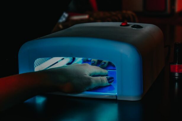 maniko nails - A hand with manicured nails being cured under a blue LED lamp for gel polish.